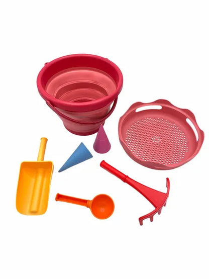 Set de jouets de plage 7-en-1 Schildkröt en version rose - vue du seau déplié, pelle, cuillère, râteau, tamis et moules.